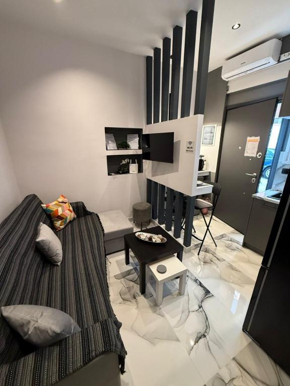 a living room with a couch and a table at Elegant Escapes 6 in Athens