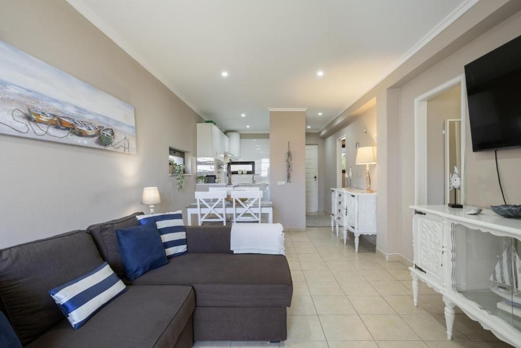 a living room with a couch and a dining room at New! Forte Beach Retreat in Caliços