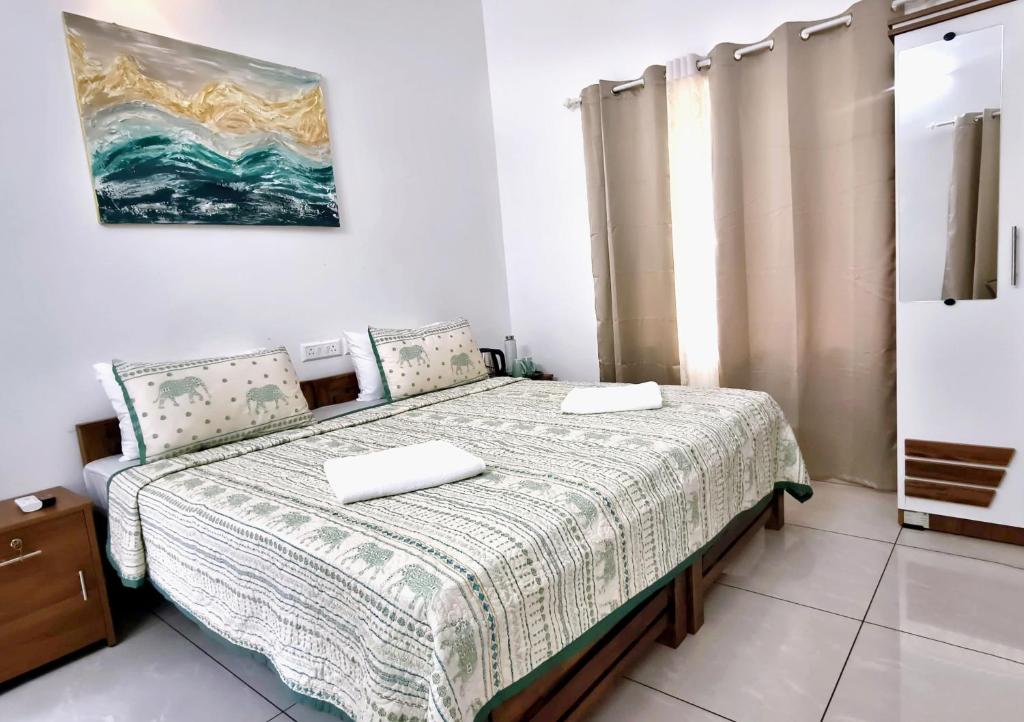 a bedroom with a bed with two pillows on it at Gypsy Walker Plus in Varkala