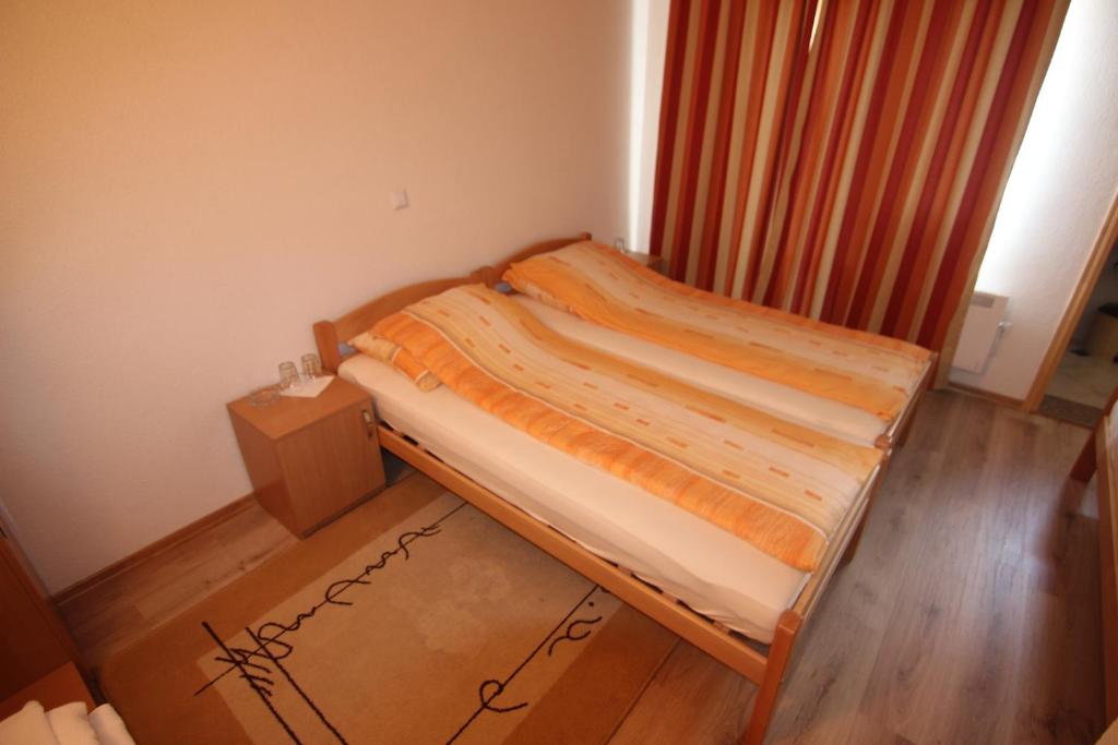 a small bedroom with a bed in a room at Rooms Zebax in Sarajevo