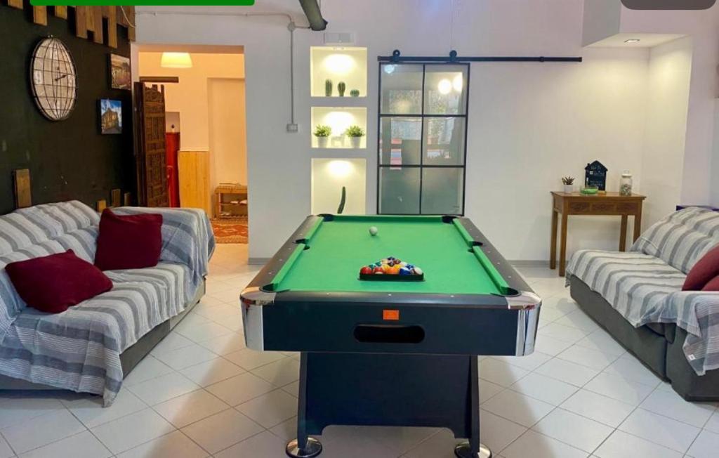 a living room with a pool table and two couches at Tabor 1 garden & parking in Naples