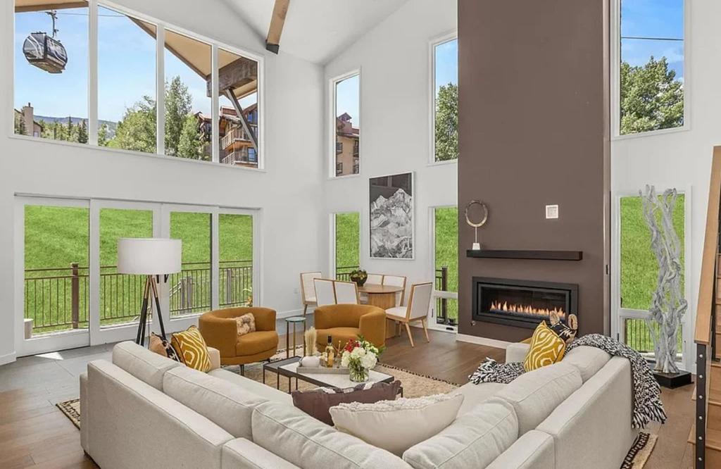 a living room with a couch and a fireplace at Ski-In Ski-Out Escape with Mountain Views in Snowm in Snowmass Village
