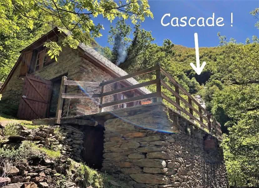 an image of an old stone house with a wooden staircase at Chalet Gure Xokoa à Melles in La Celle-sous-Gouzon