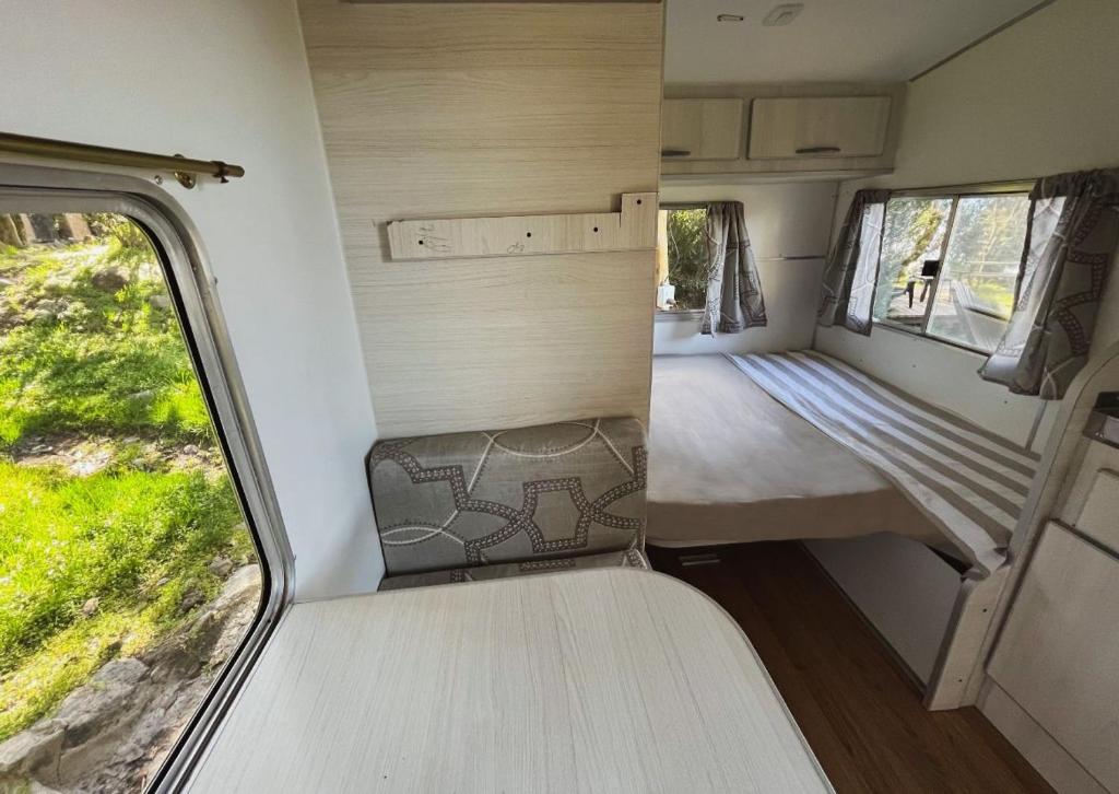 an interior of an rv with a bed and a window at Costa Traful in Villa Traful