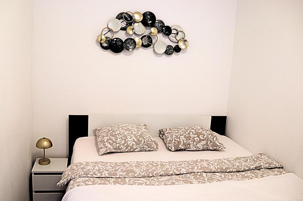a bedroom with a bed and a clock on the wall at Funktastic Central Maksimir Condo in Zagreb