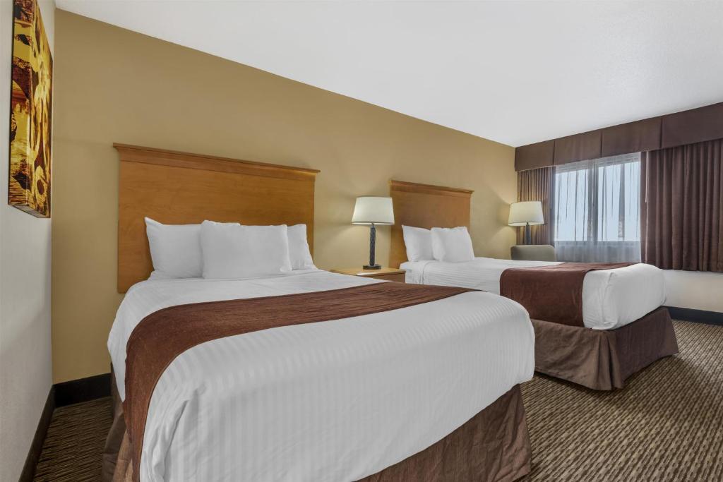 a hotel room with two beds and a window at Best Western Winchester Hotel in Winchester