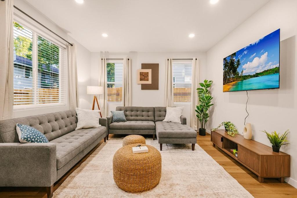 a living room with two couches and a table at Bright & Cozy 4BR Retreat Near Downtown Gresham in Gresham