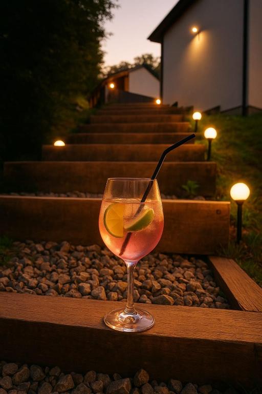 a drink in a wine glass sitting on a table at Panoramic View Bran in Bran