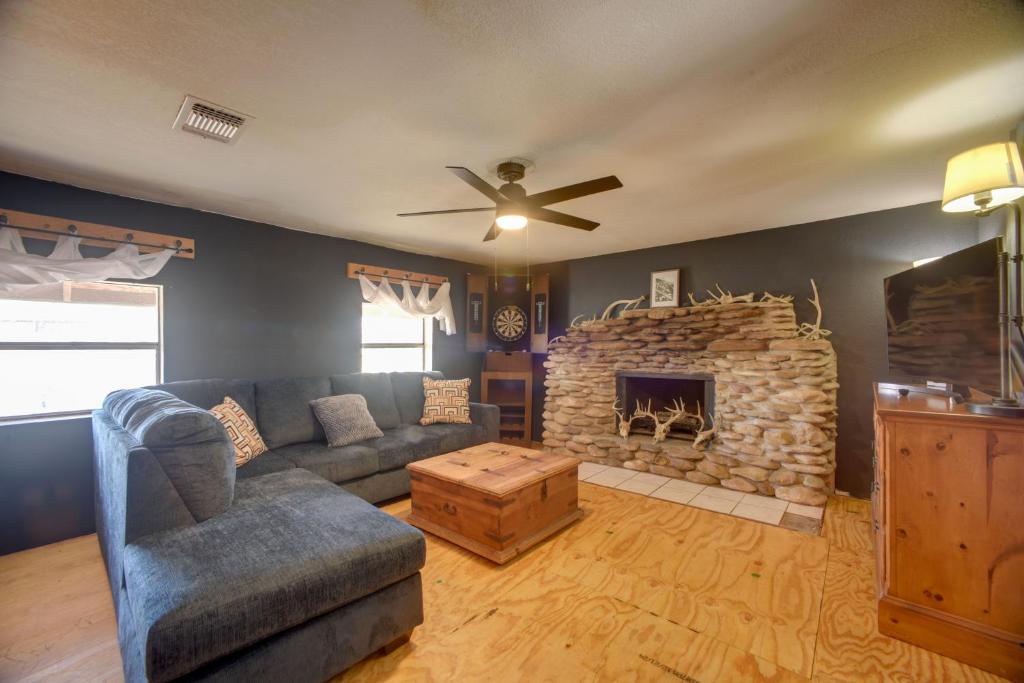a living room with a couch and a stone fireplace at 6 Mi to Laughlin AFB Cozy Studio with Private Yard in Del Rio
