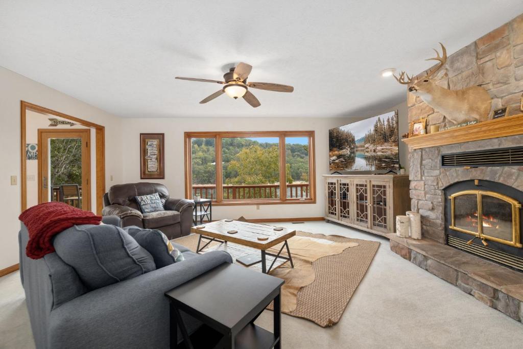 a living room with a couch and a fireplace at Beavershore-Direct Access to Beaver Lake-Sleeps 12 in Pine Top