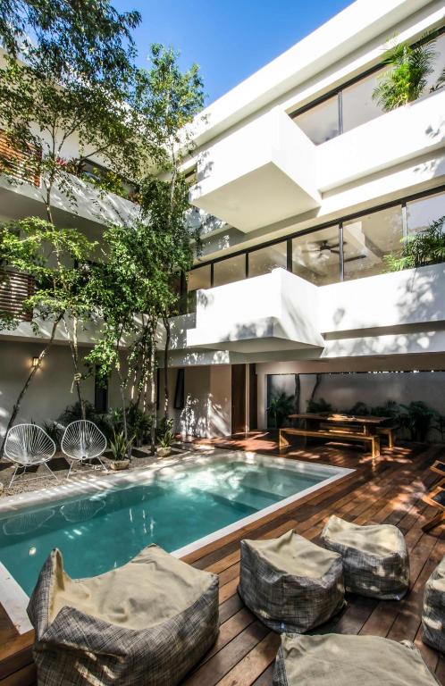an exterior view of a house with a swimming pool at Casa Kookay, 6BR Luxury Villa 3 Pools, Aldea Zama in Tulum