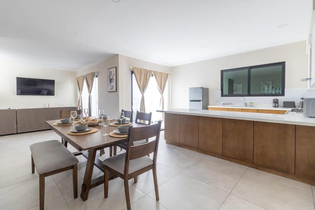 a kitchen and dining room with a table and chairs at Casa Florencia Ensenada Home 3BR WIFi & BBQ 10 Guests in Ensenada