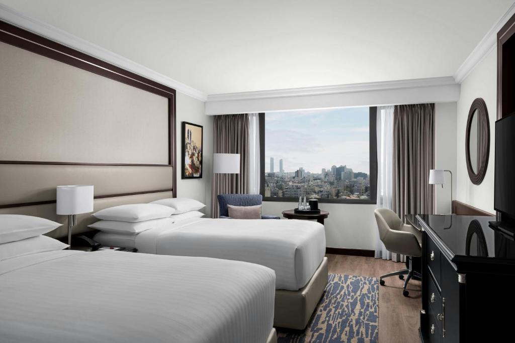 a hotel room with two beds and a window at Amman Marriott Hotel in Amman