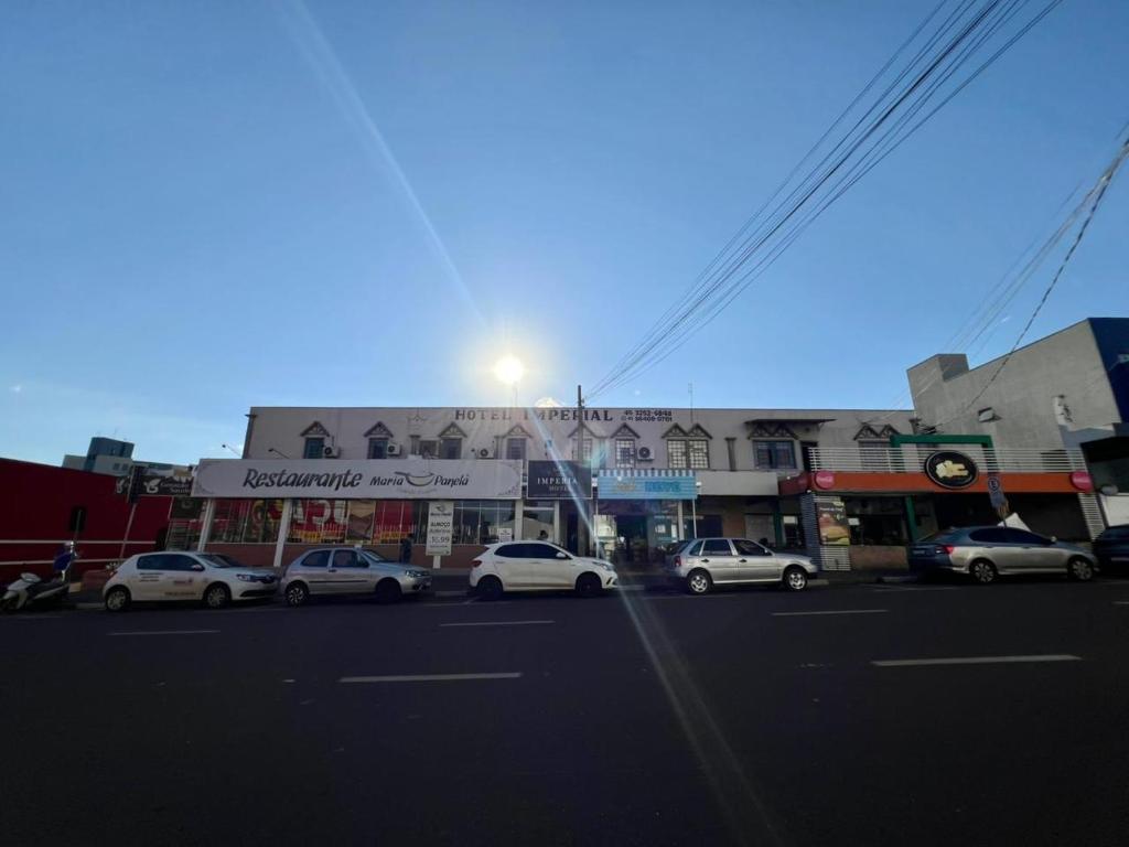 a city street with cars parked in front of buildings at Hotel Imperial in Toledo