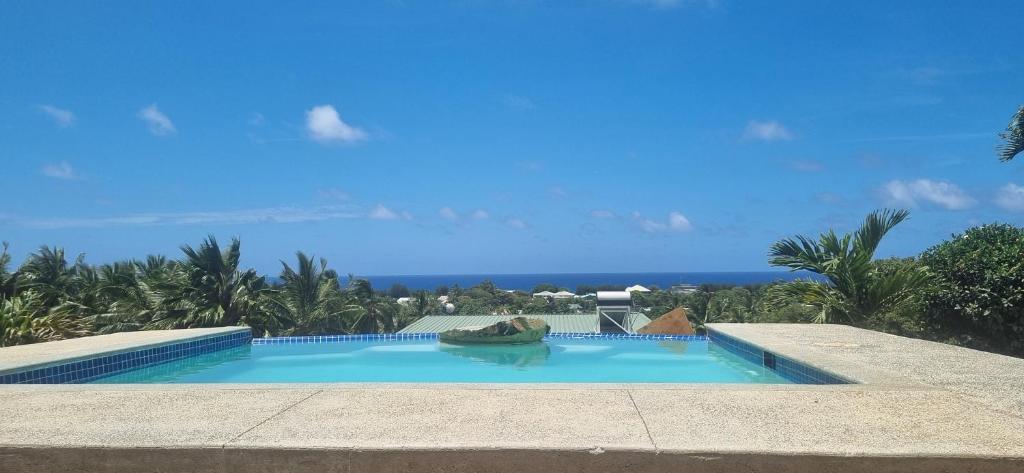 a swimming pool with a view of the ocean at Ocean Beach Town View - Infinity Pool in Avarua
