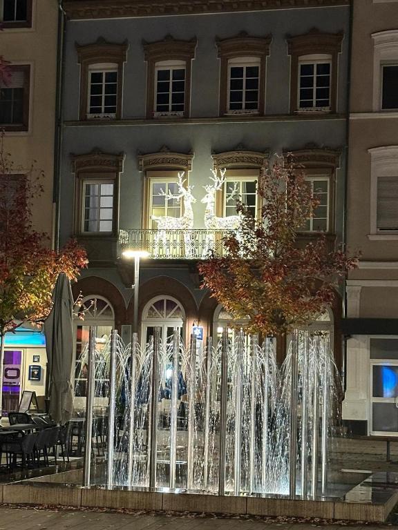a fountain in front of a building at night at Good Vibes Luxury Homes in Kaiserslautern