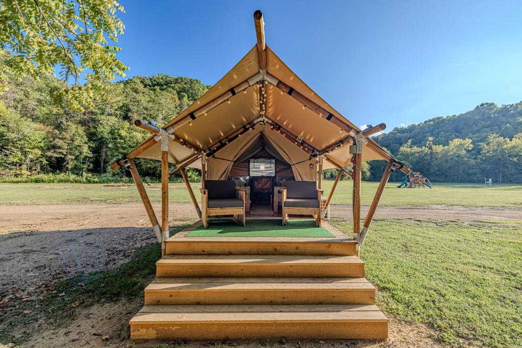 a gazebo with a table and chairs in a field at Nature Retreat Cozy tentHVACSpa Bath in Newport