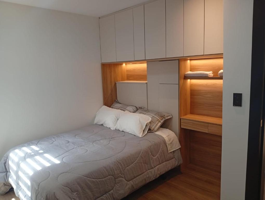 a small bedroom with a bed in a room at Casa Larrea in Cuenca