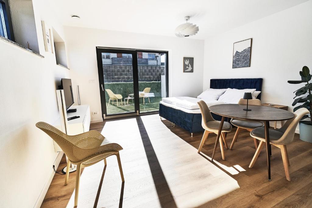 a bedroom with a bed and a table and chairs at Green Alpine Nest in Komenda