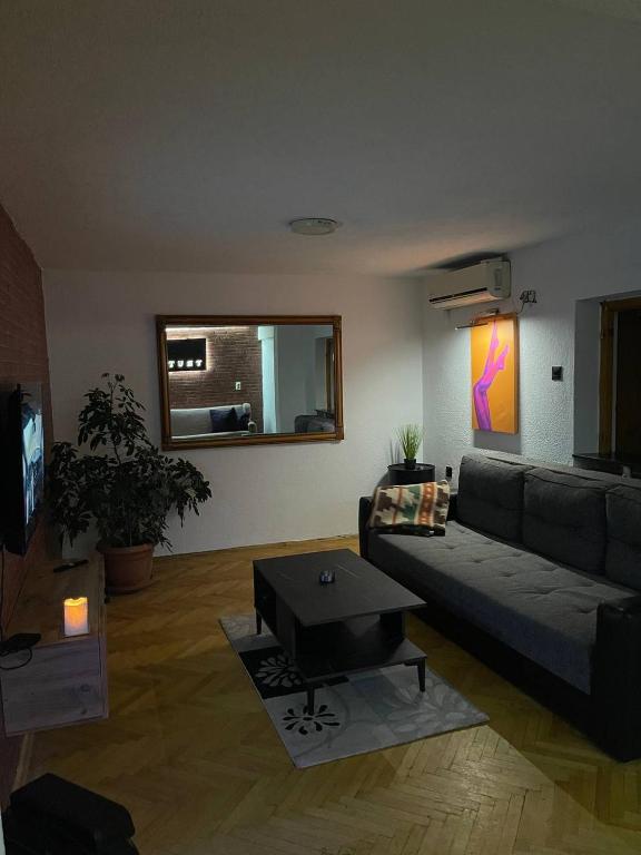 a living room with a couch and a table at TRUTH Apartment Veles in Veles