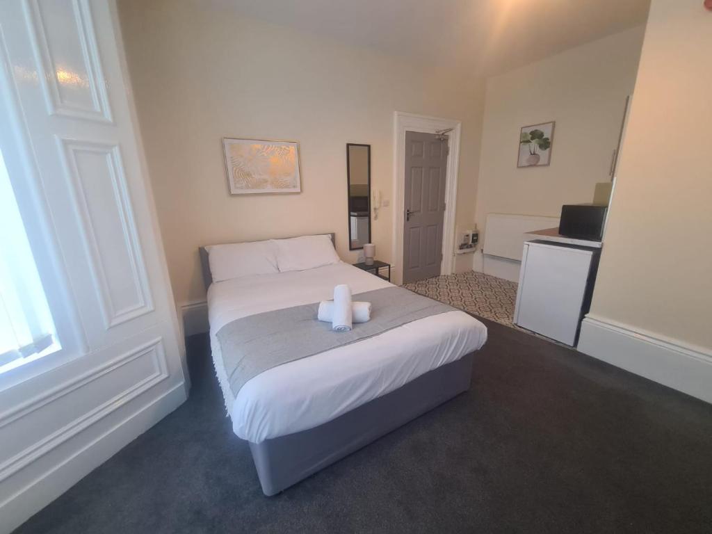 a bedroom with a bed with two candles on it at Park Place Collection in Sunderland