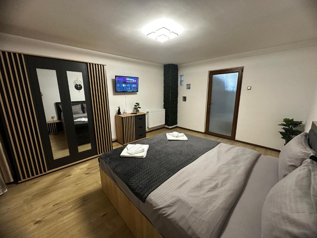 a bedroom with a large bed with two towels on it at Central Studio in Piteşti
