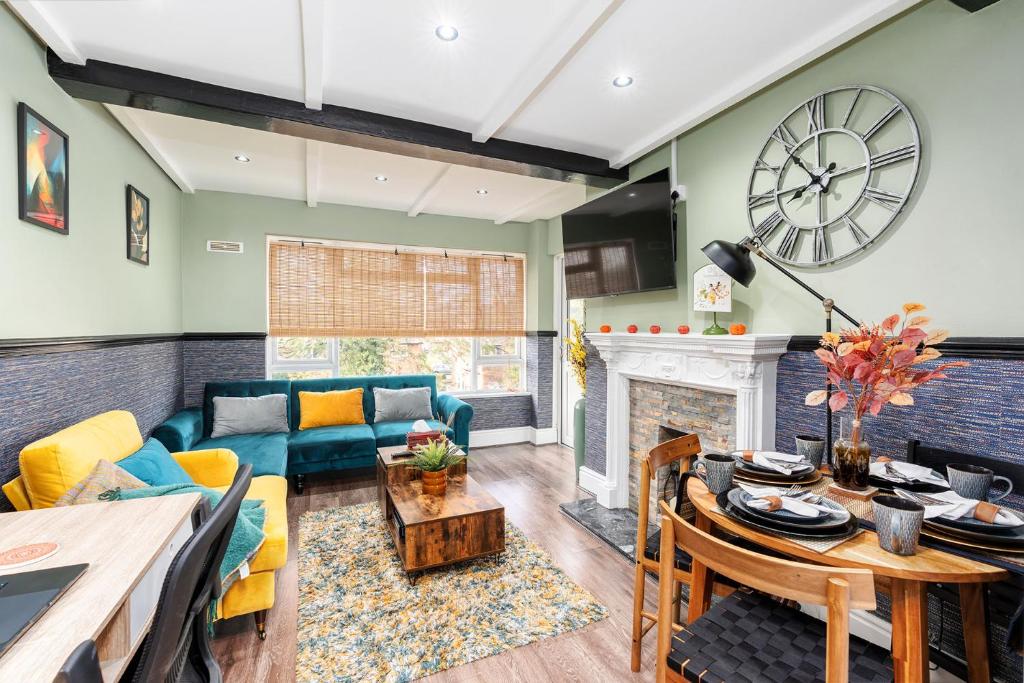 a living room with a couch and a fireplace at The Cozy Corner near NEC Birmingham Airport Entire Apartment Work Desk in Kingshurst