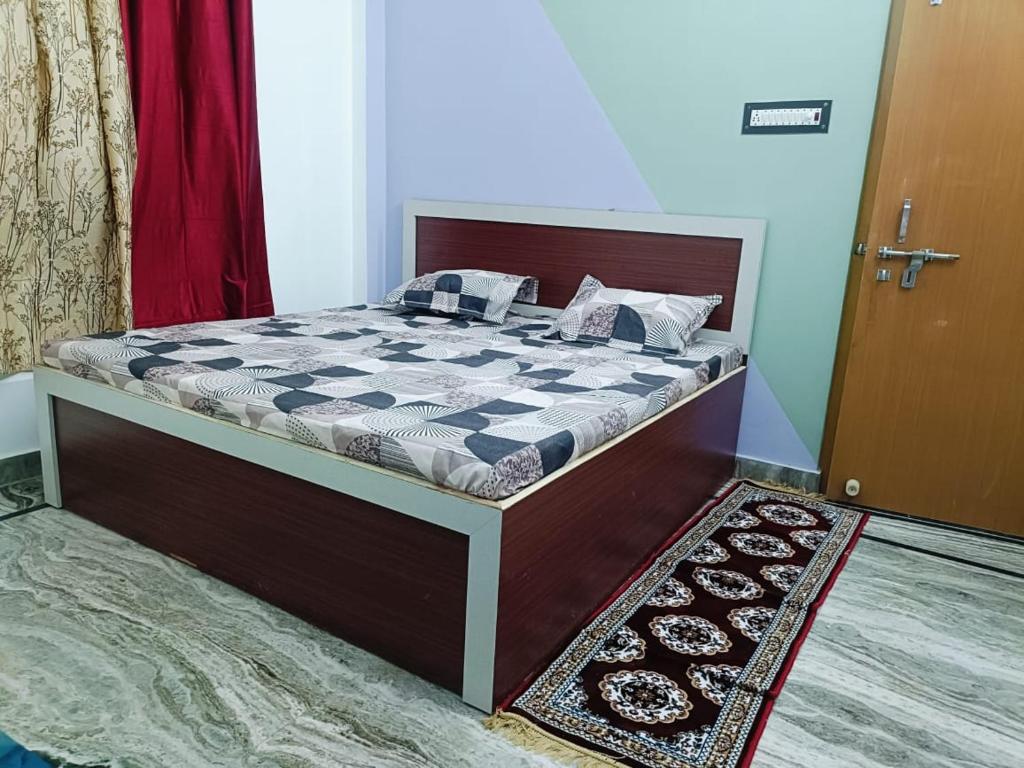 a large bed in a room with a door at Sangam guest house in Prayagraj