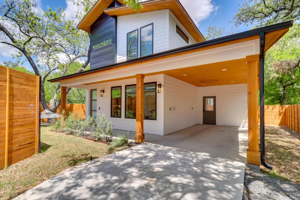 a home with a wooden fence at Chic Austin House with Spacious Backyard and Hammock in Austin