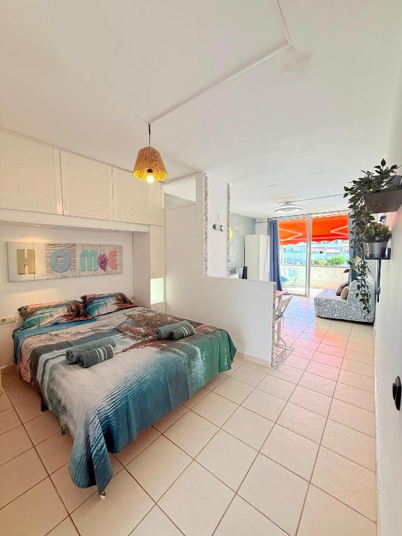 a bedroom with a large bed in a room at Sunny terrace, fast WiFi relax & remote work quiet area in Arona