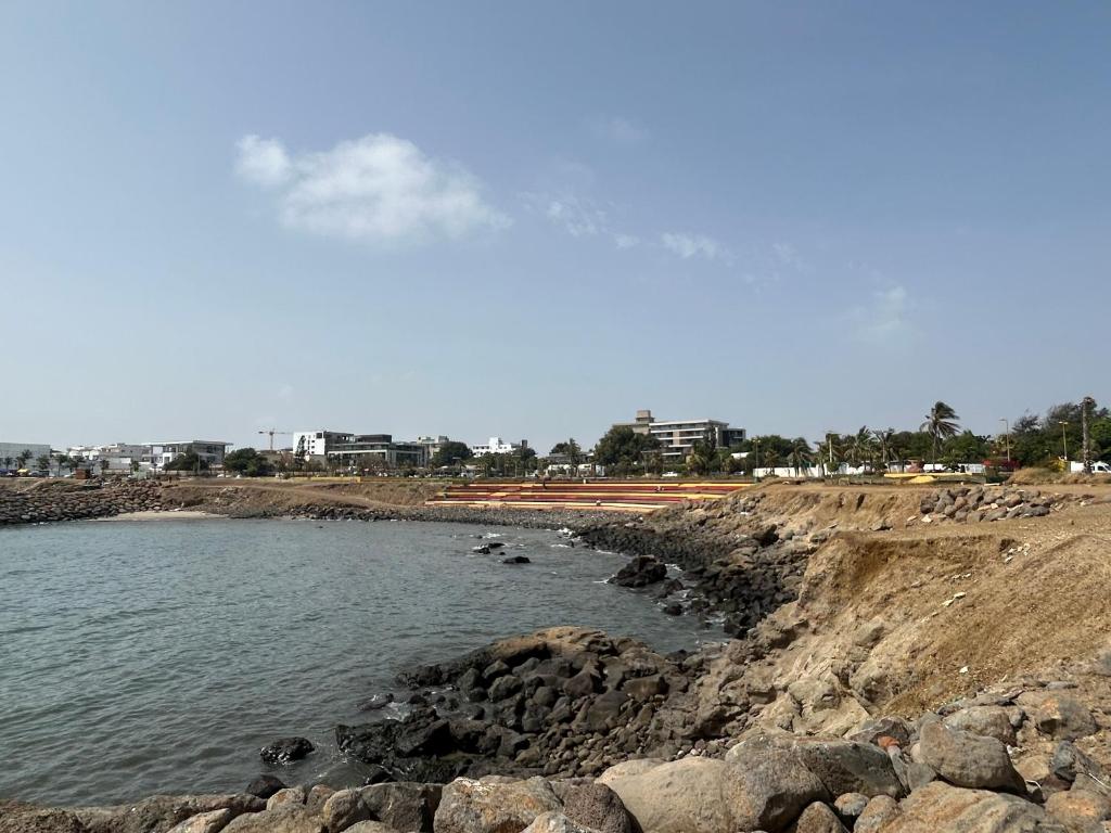 a body of water next to a rocky beach at Petit palais in Dakar