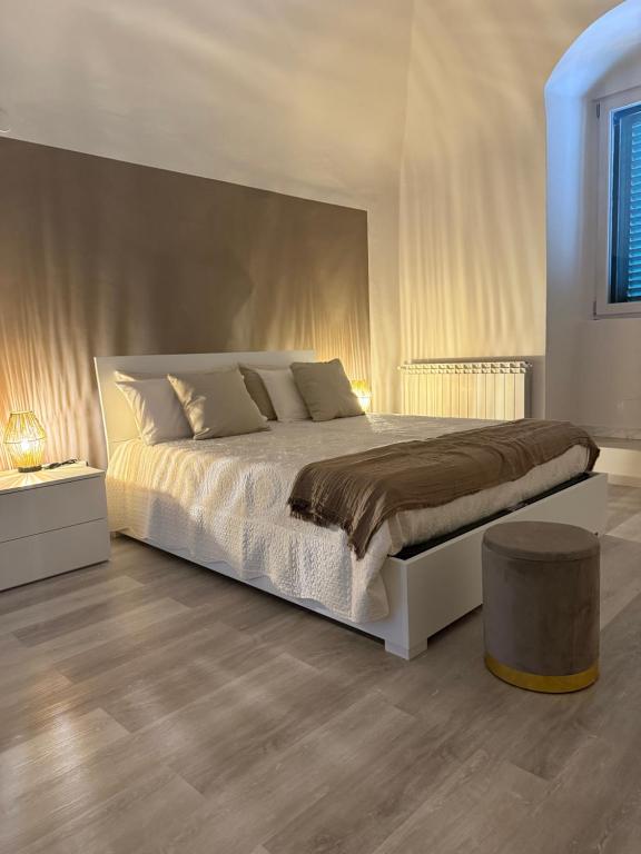 a bedroom with a large bed and a table at Ad un Passo dal Duomo in Bovino