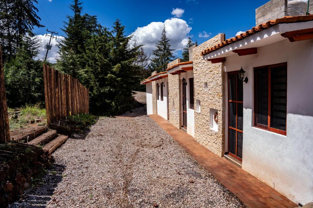 a pathway leading to a house with a fence at Cielito Lindo Hotel Boutique 