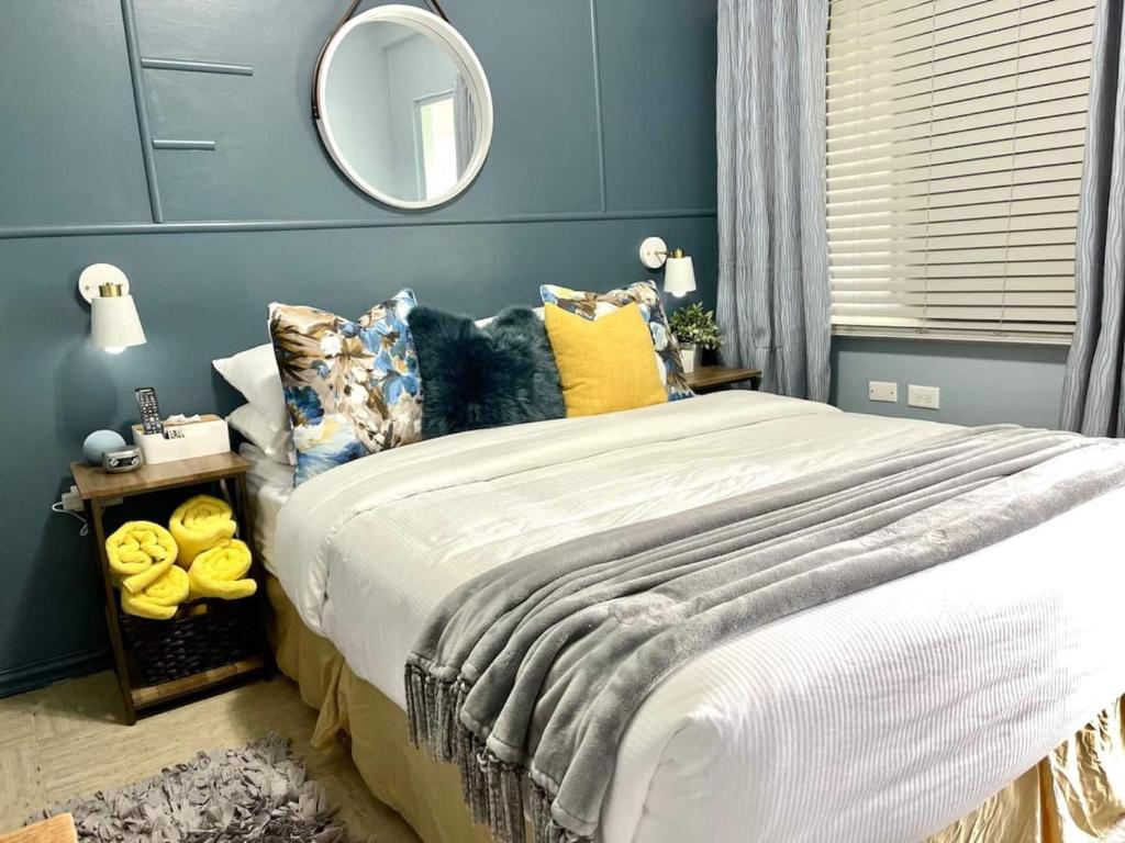 a bedroom with a large bed and a mirror at Topaz Classy, Cozy Condo Near Beaches & Airport in Crown Point