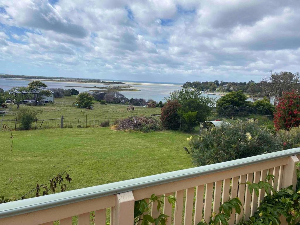 a view from the balcony of a house with a yard at The Cottage at Raheen in Mallacoota