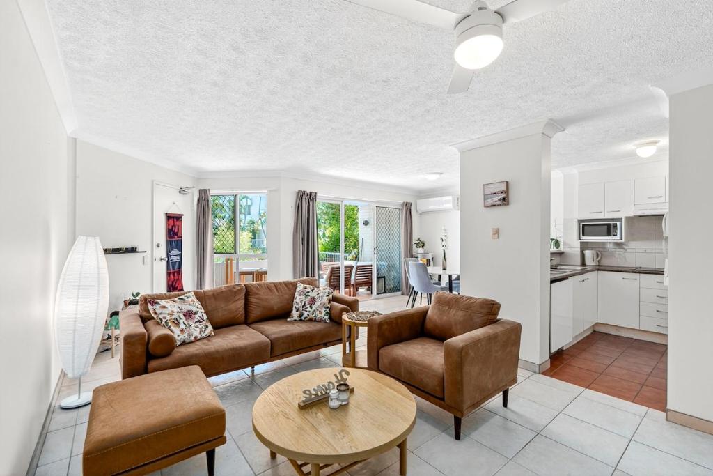 a living room with a couch and a table at Villa Sienna Hideaway 2 min walk to tramline in Gold Coast