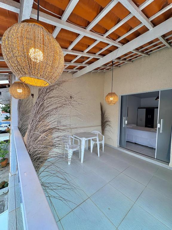 a patio with a table and chairs and lights at Casa em condominio bem no centro in São Sebastião