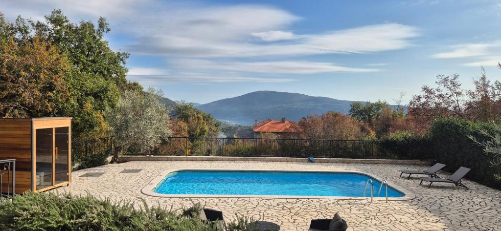 a swimming pool with a view of a mountain at Villa Belle Air in Herceg-Novi