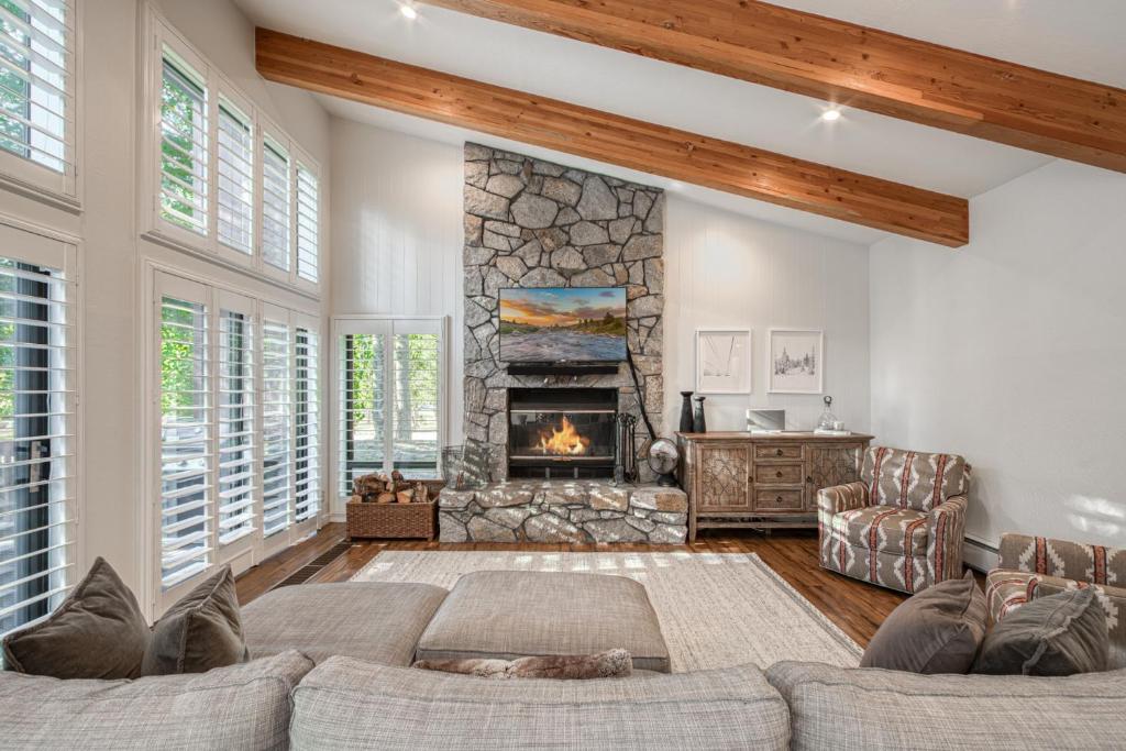 a living room with a couch and a fireplace at Ridge Court # 13 by Tahoe Getaways - 3BR Palisades at Alpine Condo w Ski Shuttle & Tennis! in Alpine Meadows