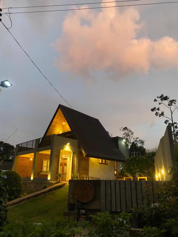 a house with a black roof at night at Avons Residence Hanthana in Kandy