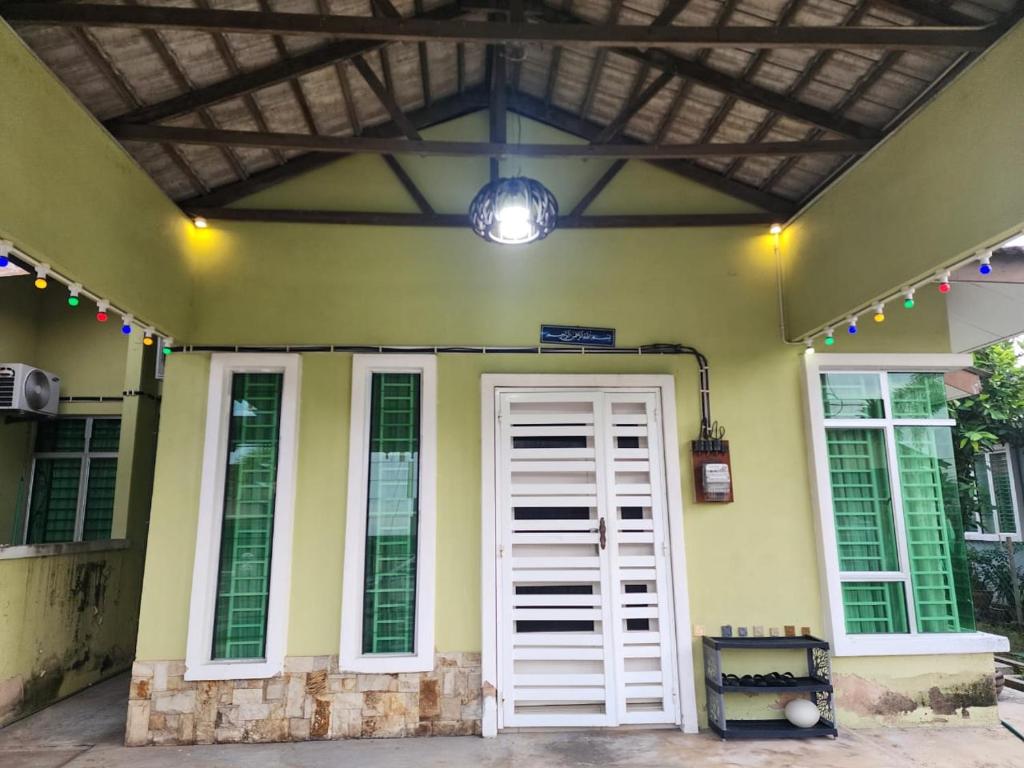 a house with a white door and a ceiling at HOMESTAY RIZQI - MUS LIM Only in Air Molek