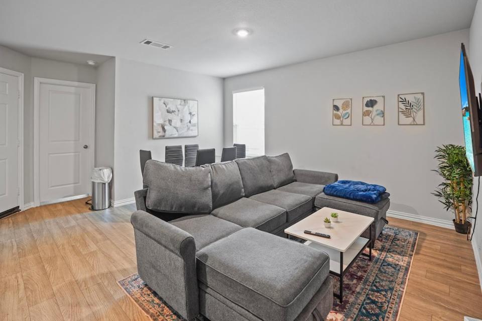 a living room with a couch and a table at Modern and Cozy Home in HTX in Houston