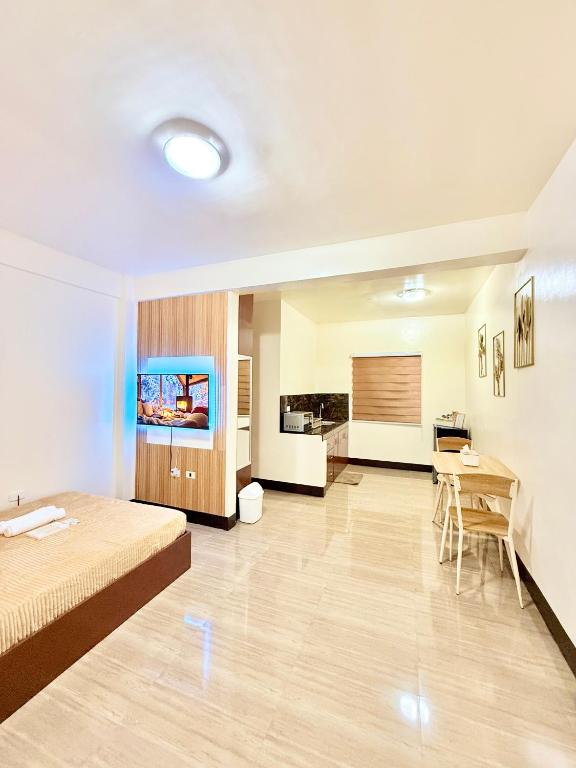 a large room with a bed and a table at JL Suites Calbayog in Calbayog