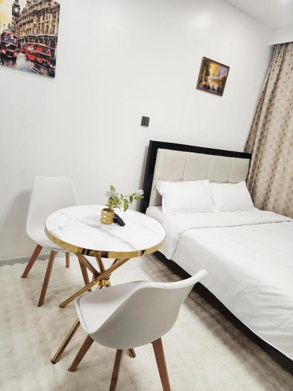 a bedroom with a bed and a table and a chair at Mathel Studio Home in Marimbeti