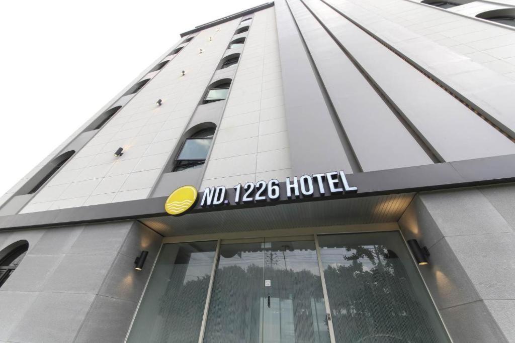 a building with a sign on the side of it at Sasang ND 1226 Hotel in Busan