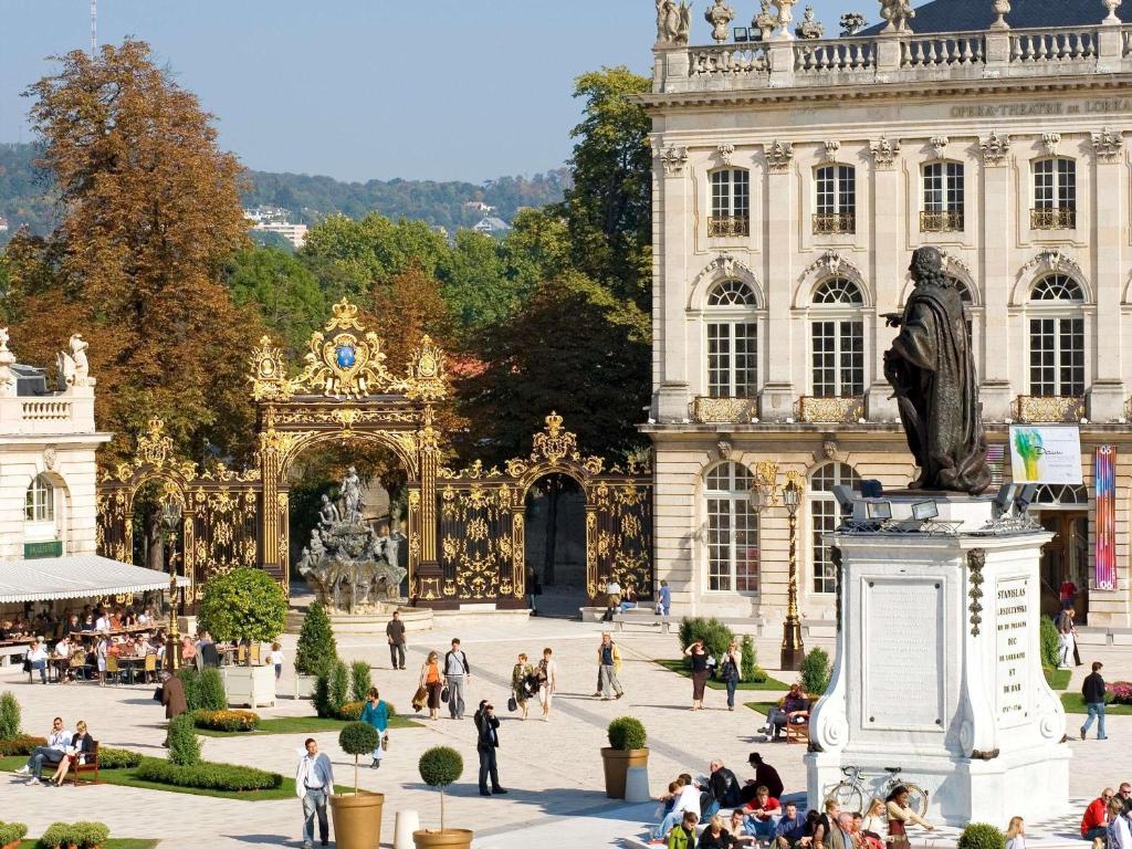a large building with a statue in front of it at Mercure Nancy Centre Place Stanislas in Nancy