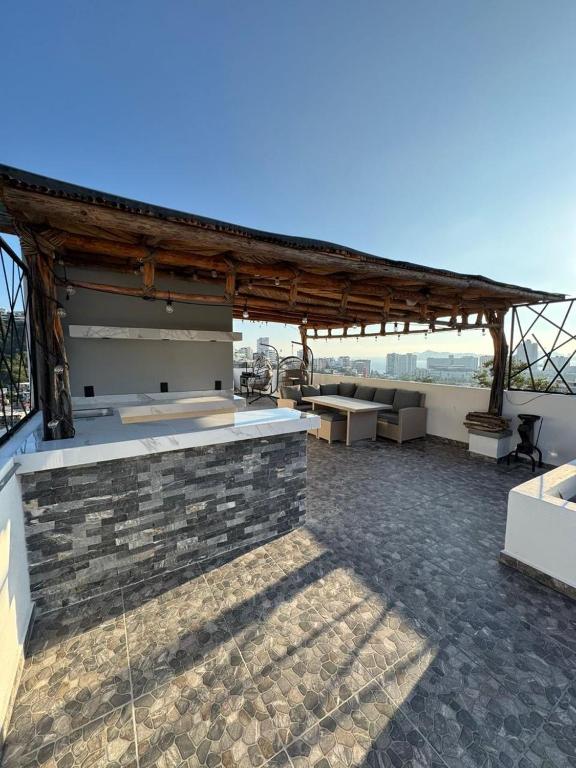 a pavilion with benches and tables on a patio at Villa Yolanda in Acapulco