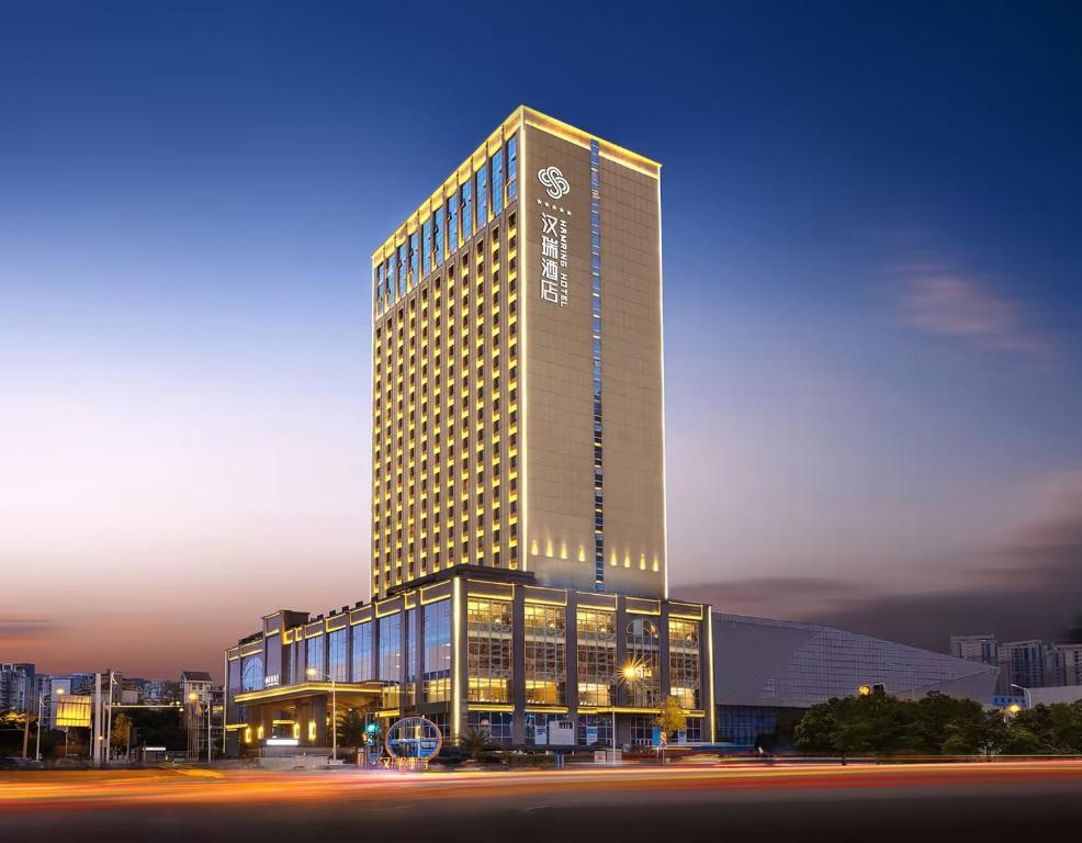 a tall building with a lot of windows at Deyang Hamring Hotel in Deyang