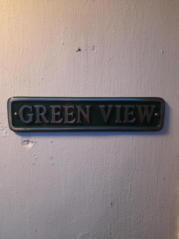 a green view sign hanging on a wall at Greenview in Didcot