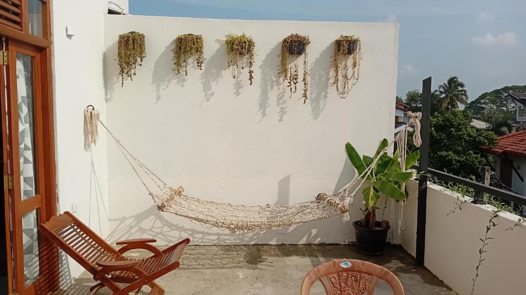 a porch with a hammock on a balcony at Ariyana Sky Suites in Matara